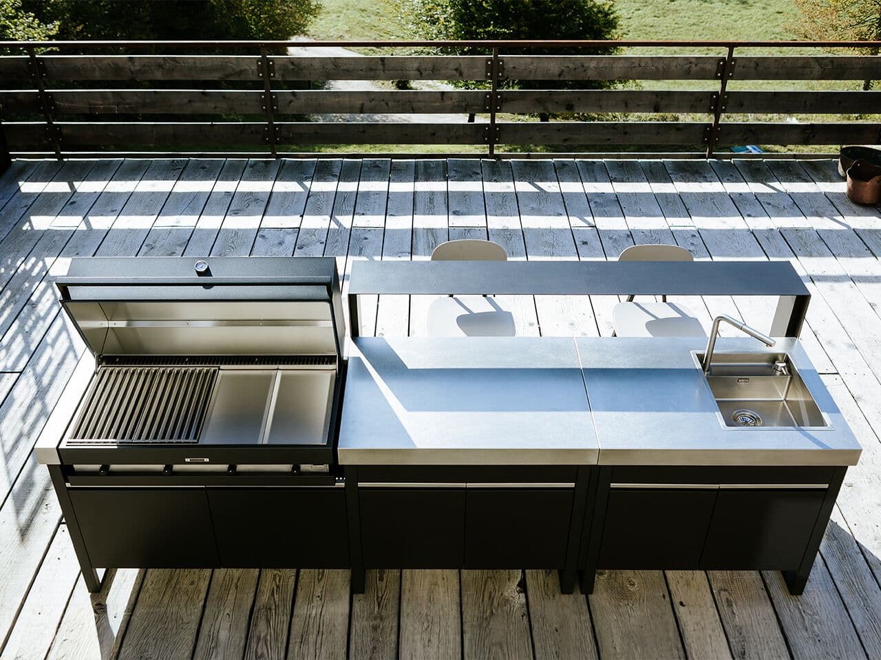 Fogher steel outdoor kitchen with a lava stone cooktop, in a garden on Lake Garda
